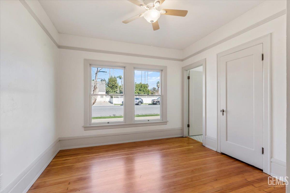 Undisclosed Address Bakersfield, CA 93305 - Photo 25 of 49 a view of an empty room with wooden floor and a window