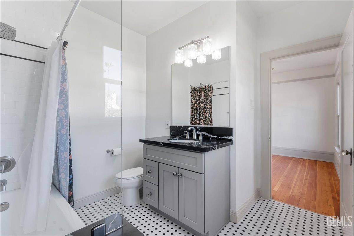 Undisclosed Address Bakersfield, CA 93305 - Photo 28 of 49 a bathroom with a sink a toilet a mirror and shower
