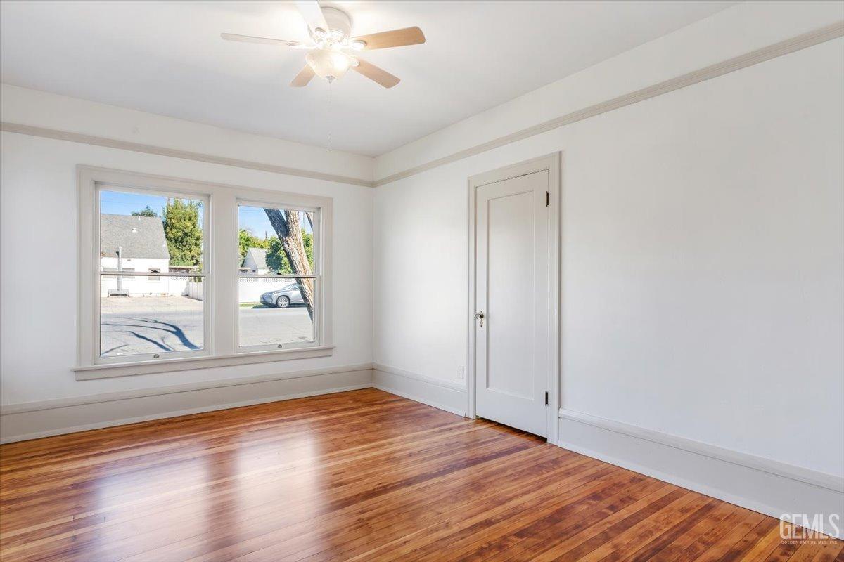 Undisclosed Address Bakersfield, CA 93305 - Photo 29 of 49 a view of an empty room with wooden floor and a window