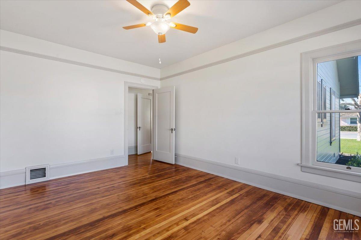 Undisclosed Address Bakersfield, CA 93305 - Photo 30 of 49 a view of an empty room with wooden floor and a window