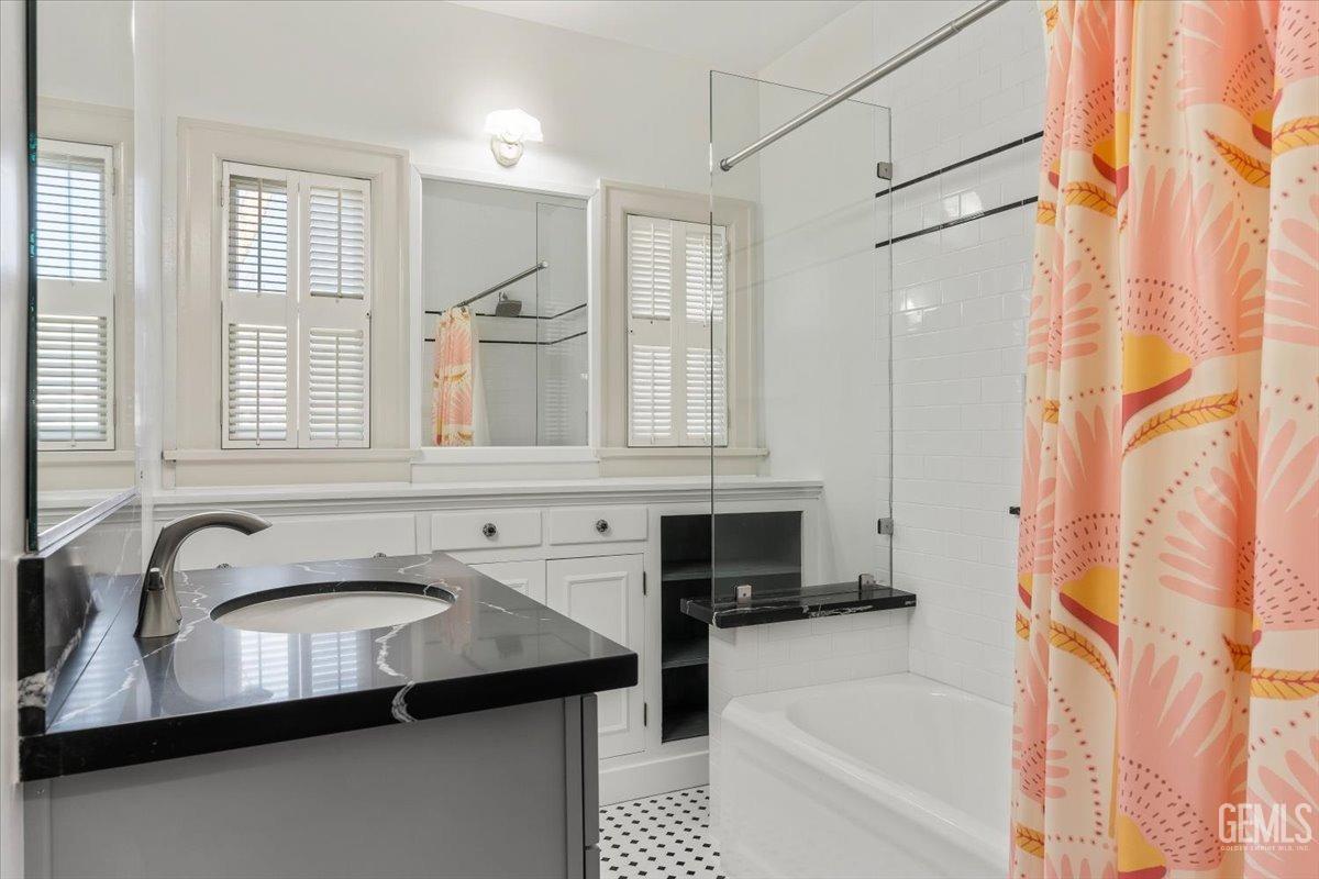 Undisclosed Address Bakersfield, CA 93305 - Photo 32 of 49 a bathroom with a sink a mirror and a bathtub