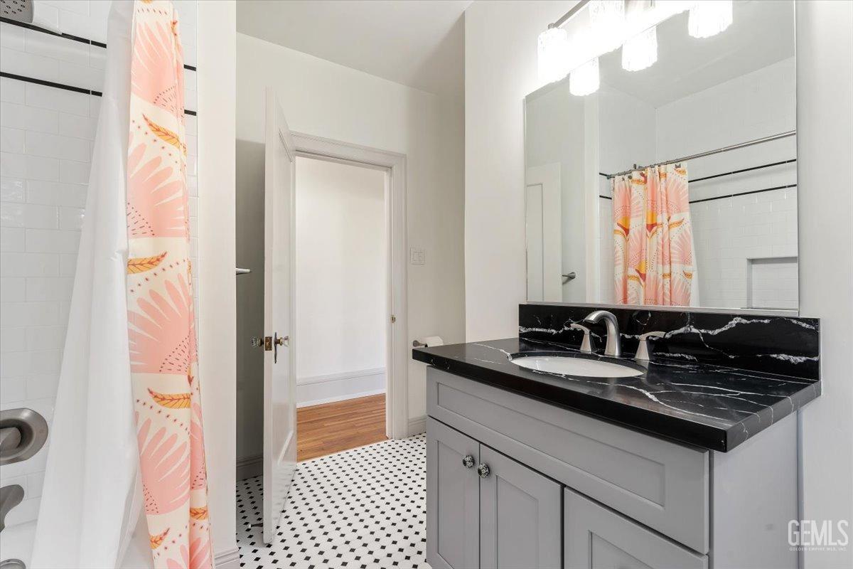 Undisclosed Address Bakersfield, CA 93305 - Photo 33 of 49 a bathroom with a granite countertop sink a mirror and a shower