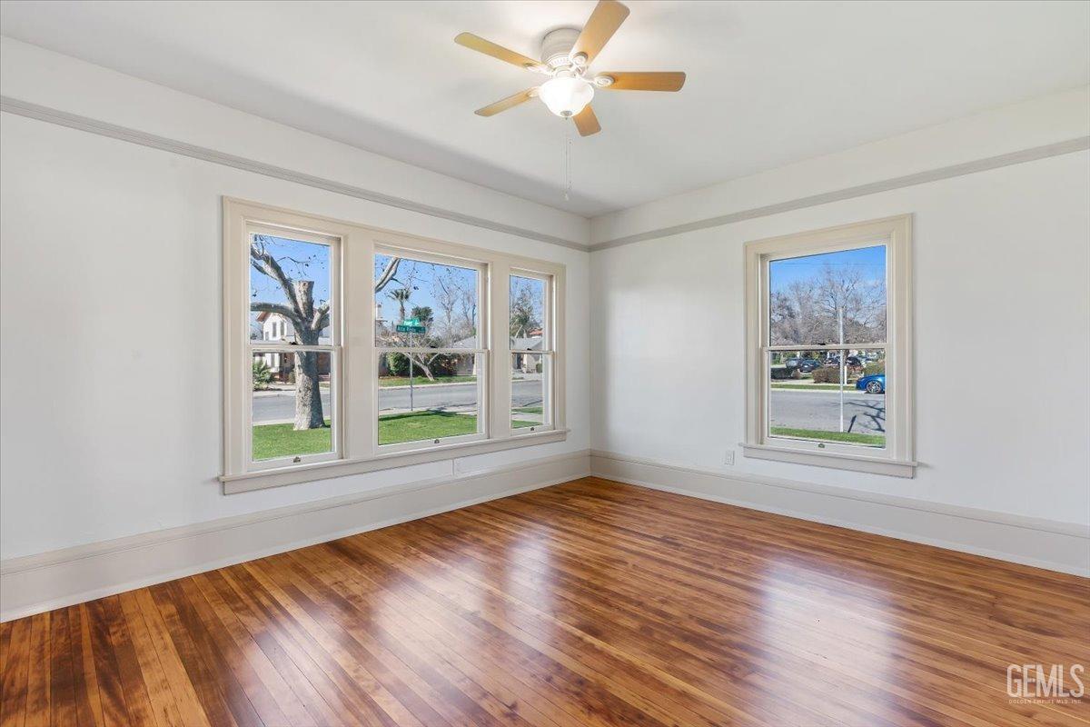 Undisclosed Address Bakersfield, CA 93305 - Photo 34 of 49 a view of an empty room with wooden floor and a window