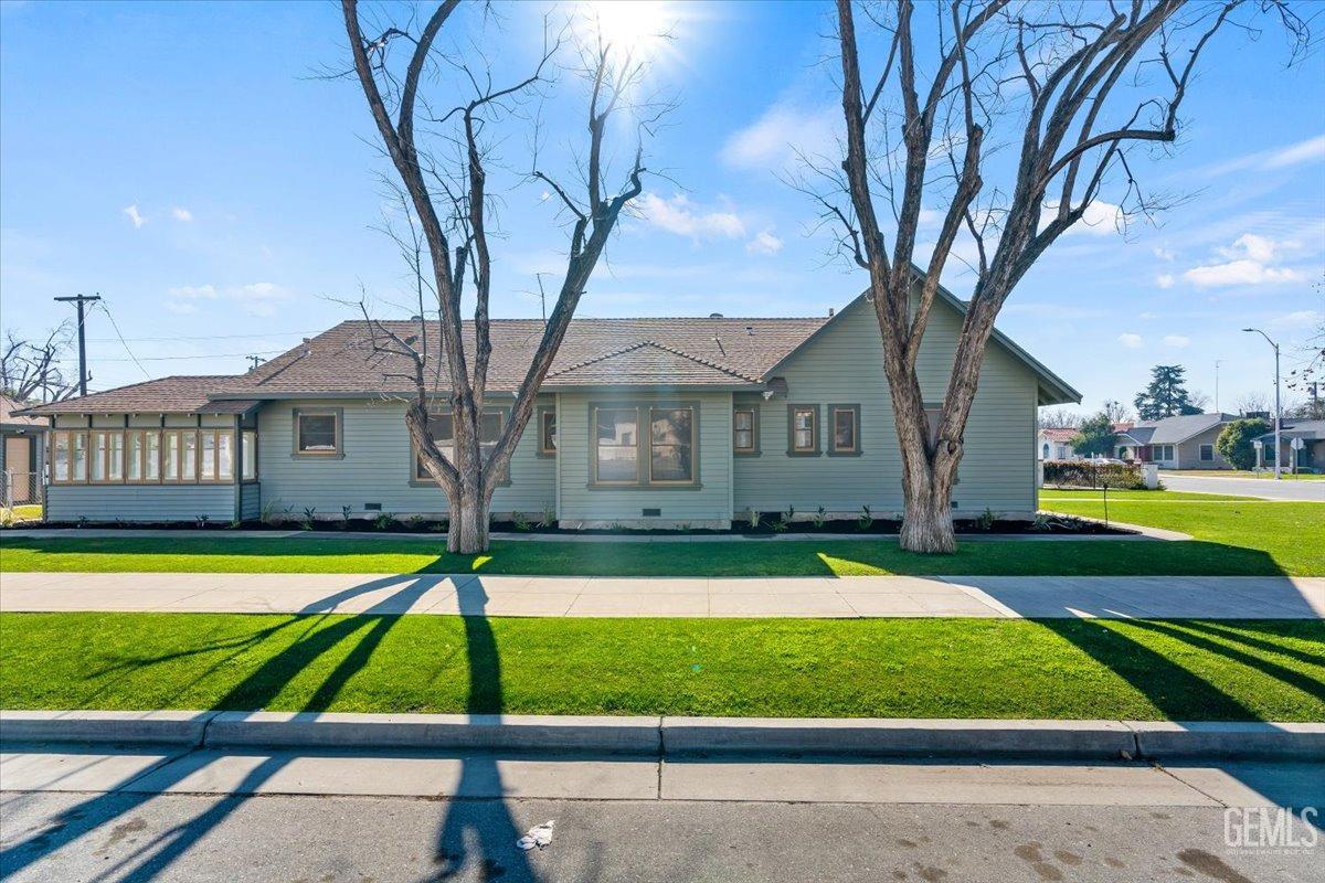 Undisclosed Address Bakersfield, CA 93305 - Photo 7 of 49 a front view of a house with a yard table and chairs
