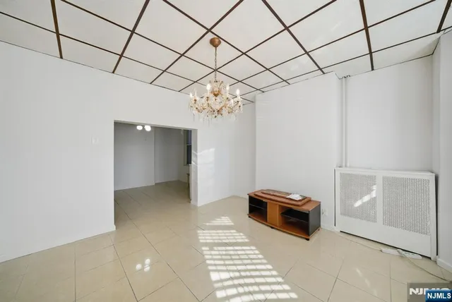 a view of a livingroom with a chandelier fan and furniture