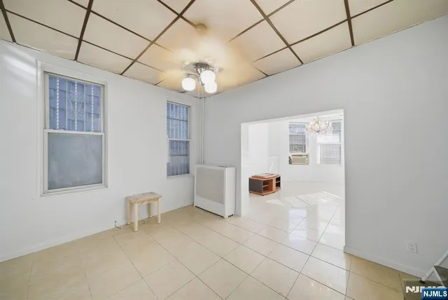 a view of a livingroom with a chandelier fan
