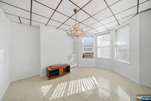 a view of a room with window and chandelier