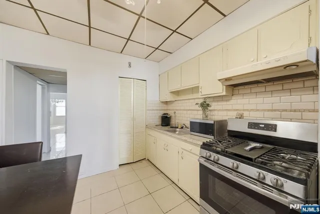 a kitchen with stainless steel appliances a stove refrigerator sink and cabinets
