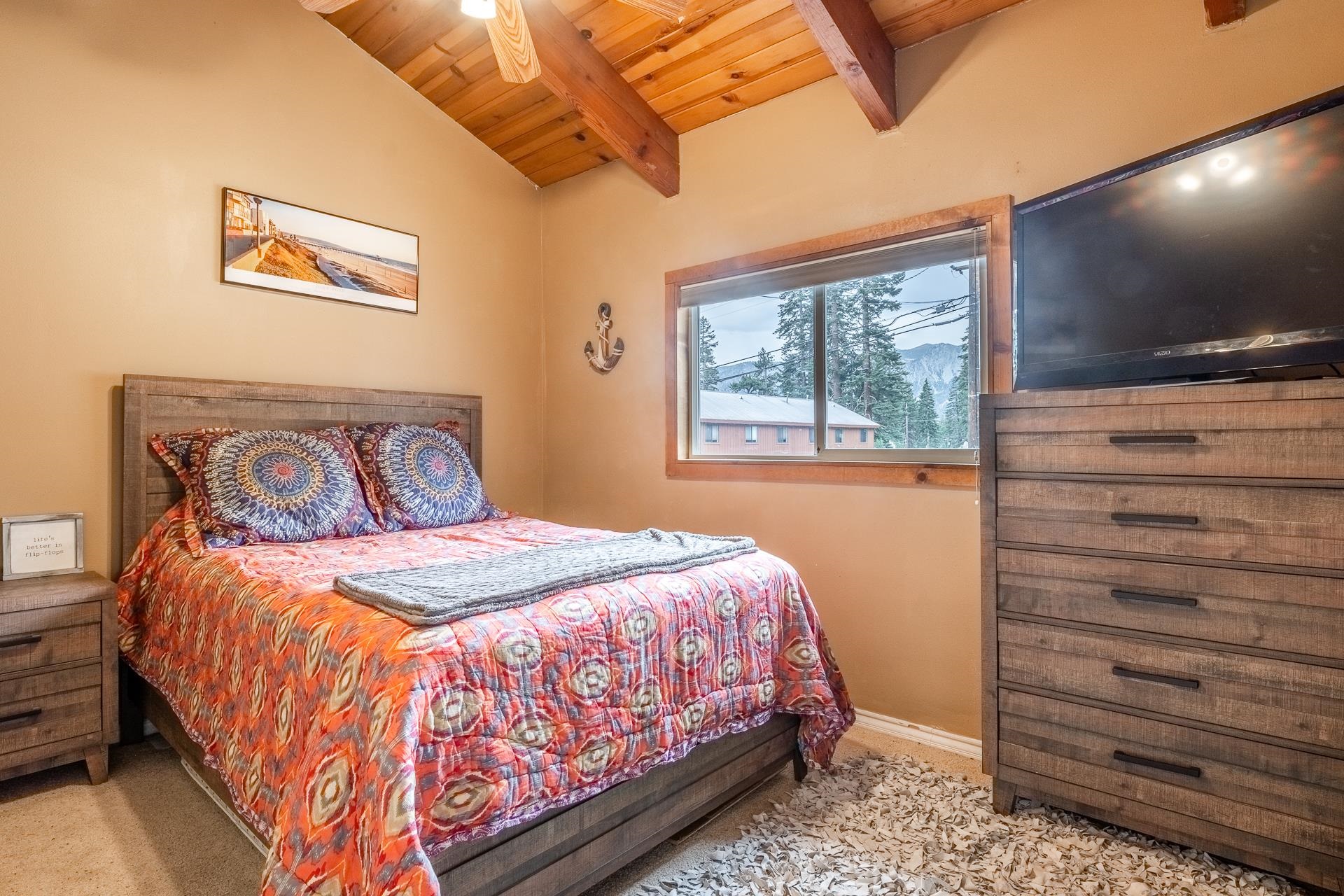 182 Davison Road Mammoth Lakes, CA 93546 - Photo 14 of 25 a bedroom with a bed and a flat screen tv