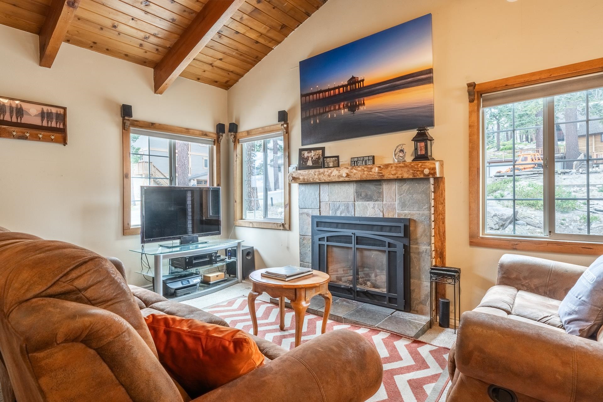 182 Davison Road Mammoth Lakes, CA 93546 - Photo 3 of 25 a living room with furniture a flat screen tv and a fireplace