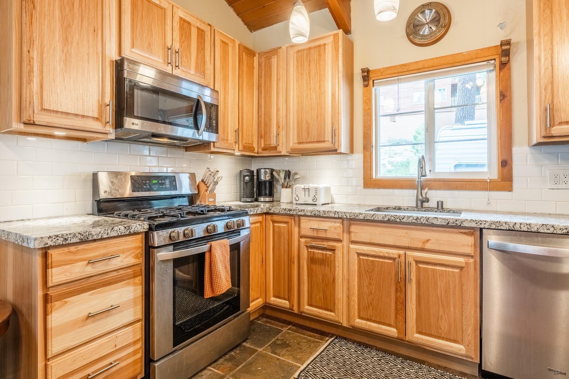 182 Davison Road Mammoth Lakes, CA 93546 - Photo 9 of 25 a kitchen with stainless steel appliances granite countertop a stove a sink and a microwave