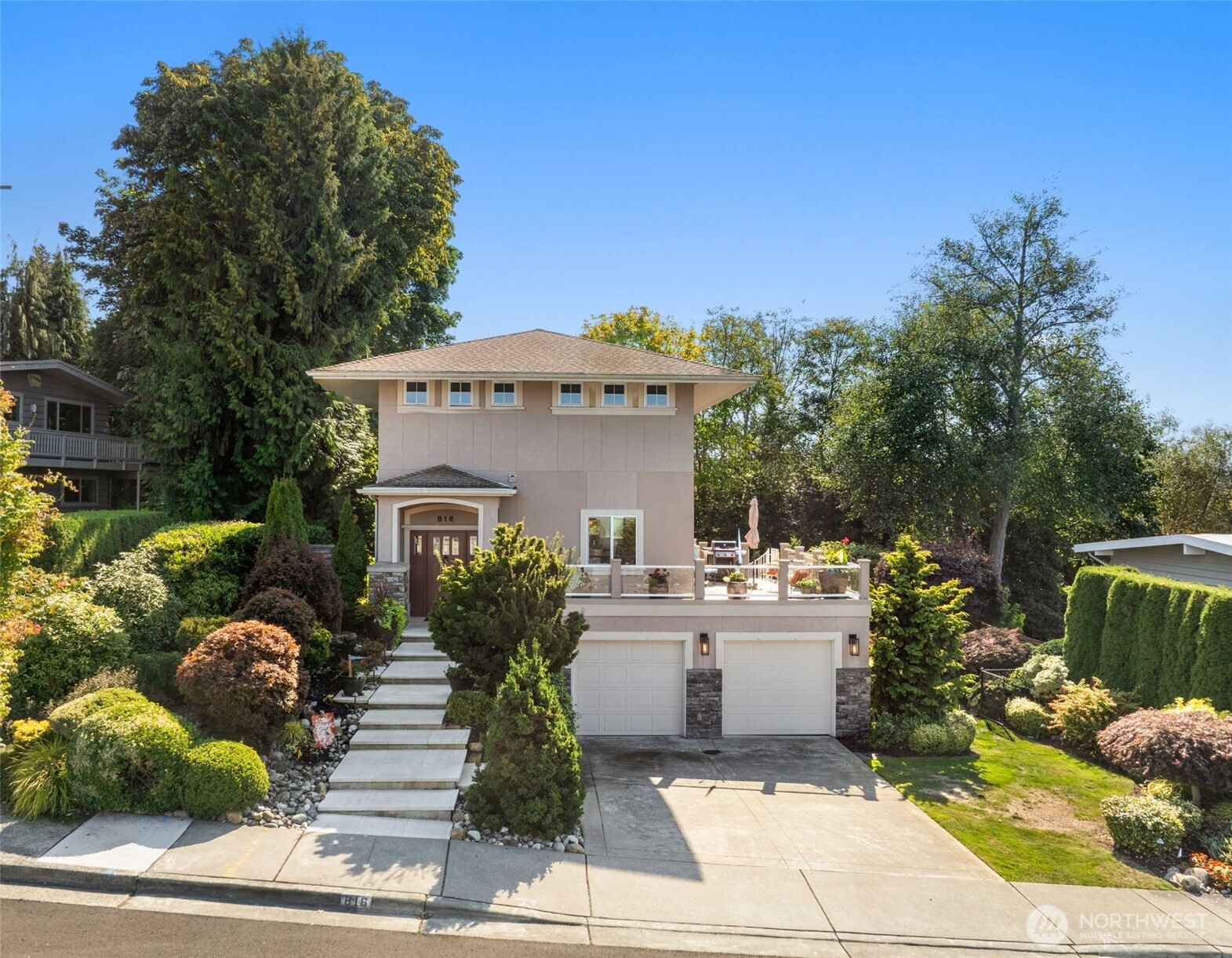 a front view of a house with a garden