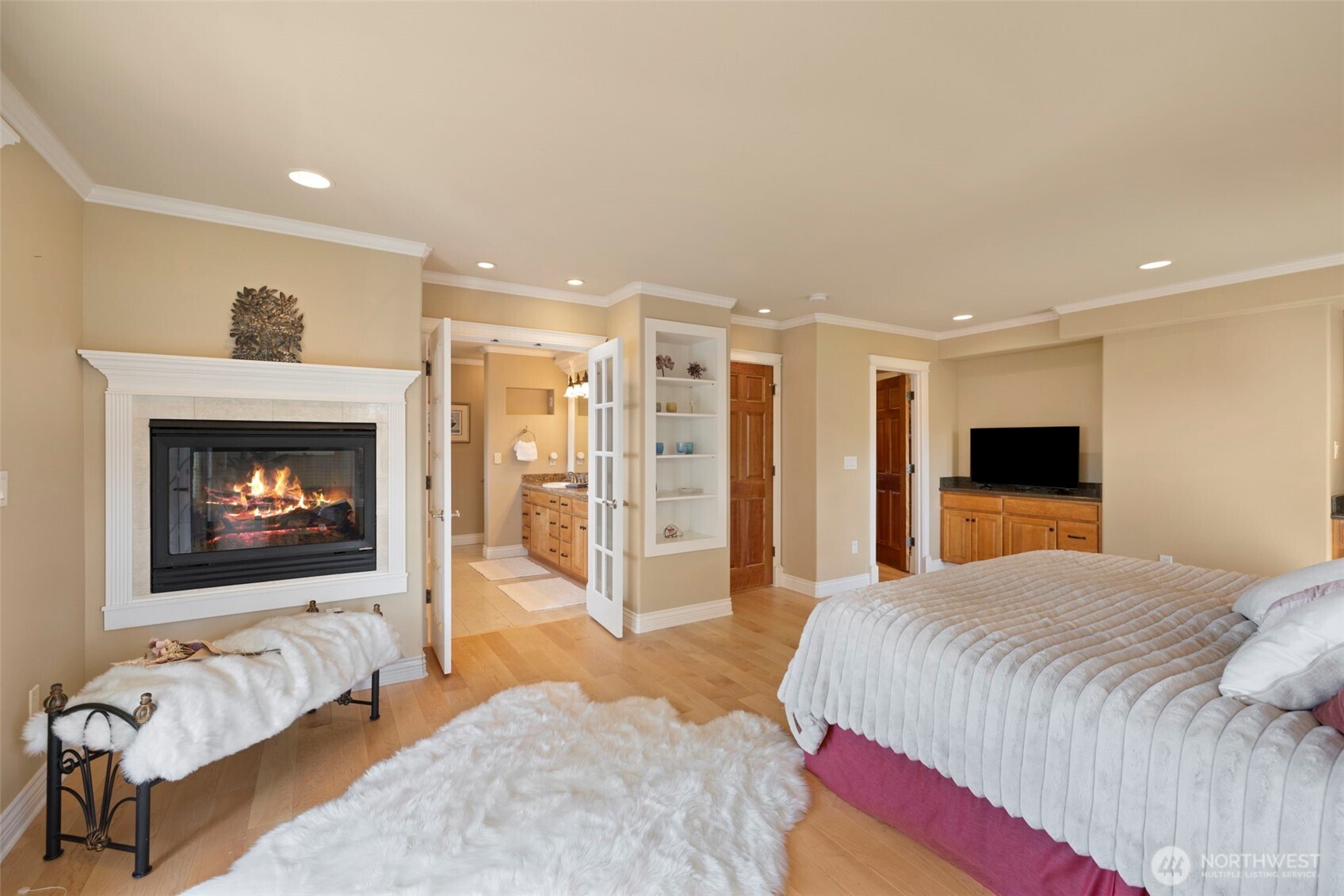 816 Walnut Street Edmonds, WA 98020 - Photo 19 of 32 a spacious bedroom with a bed and a fireplace