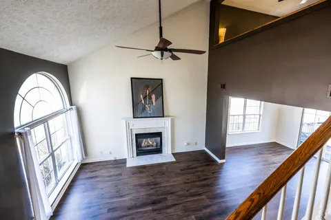 a view of empty room with wooden floor and fireplace