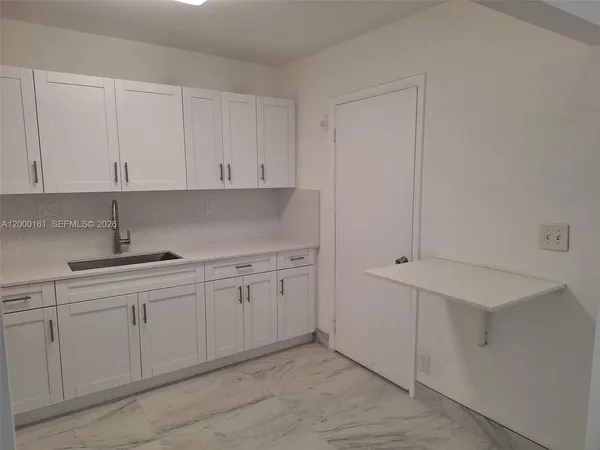 a kitchen with white cabinets