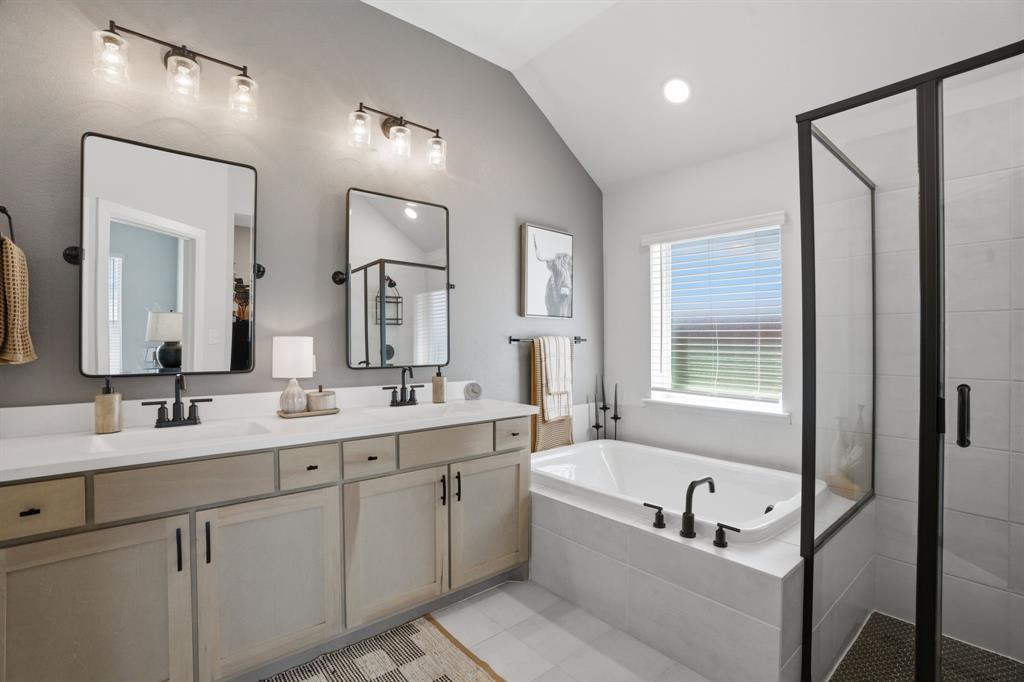 1632 Cotton Road Van Alstyne, TX 75495 - Photo 18 of 40 a bathroom with a tub a sink double vanity and a mirror