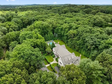 an aerial view of a house with yard