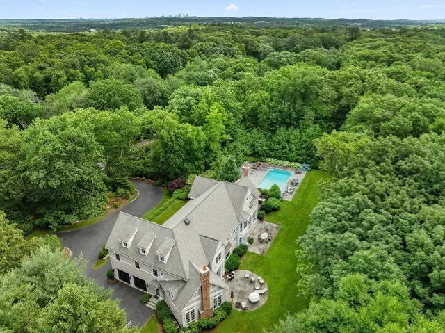 an aerial view of a house with a yard