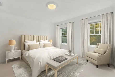 a bedroom with a bed a couch and a window