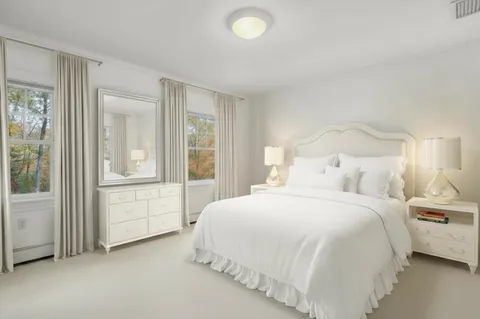 a spacious bedroom with a bed and a window