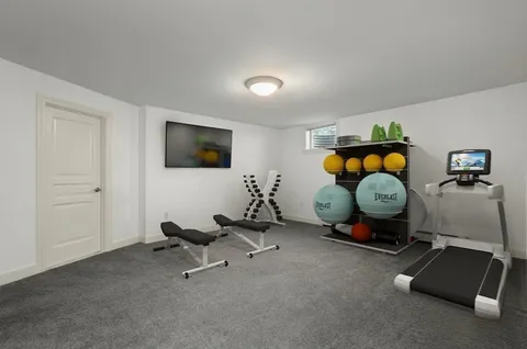 a room with gym equipment and a mirror