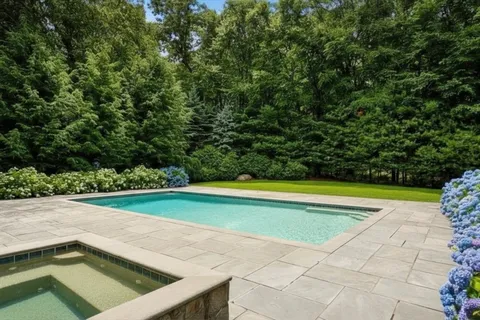 a view of swimming pool with a yard