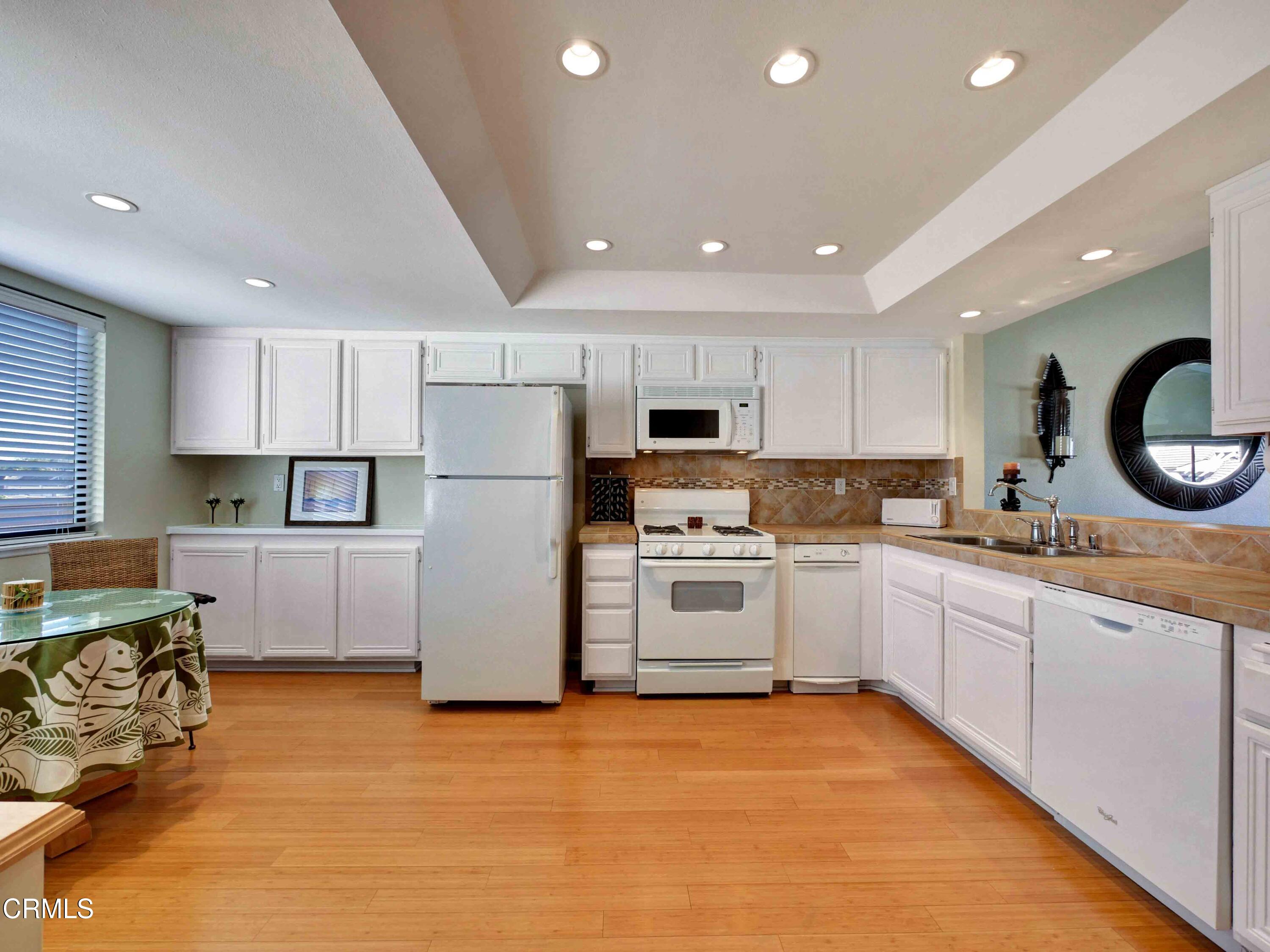 558 Terrace View Place Port Hueneme, CA 93041 - Photo 17 of 52 a kitchen with stainless steel appliances granite countertop a stove sink and cabinets