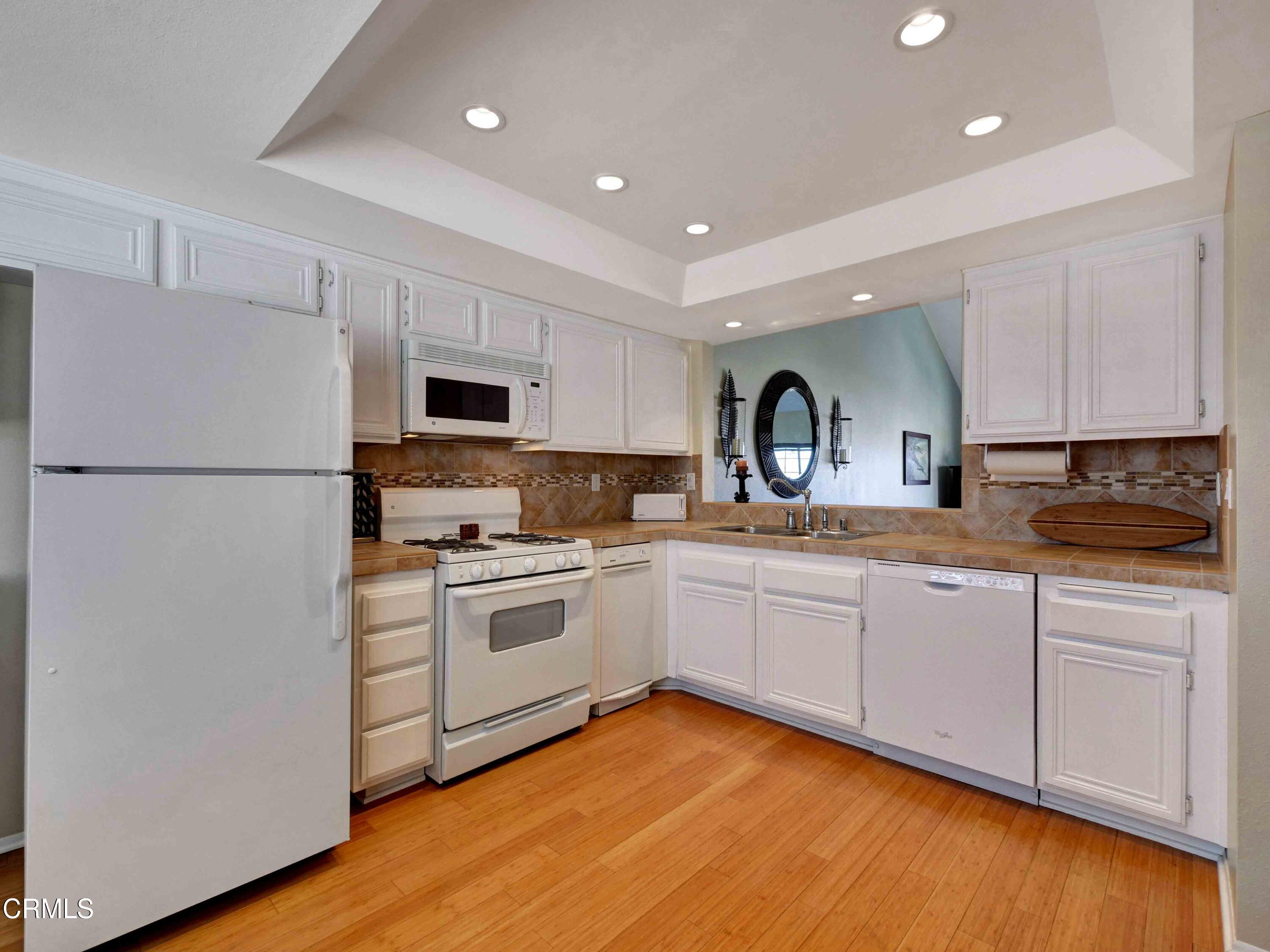 558 Terrace View Place Port Hueneme, CA 93041 - Photo 18 of 52 a kitchen with a refrigerator stove and sink