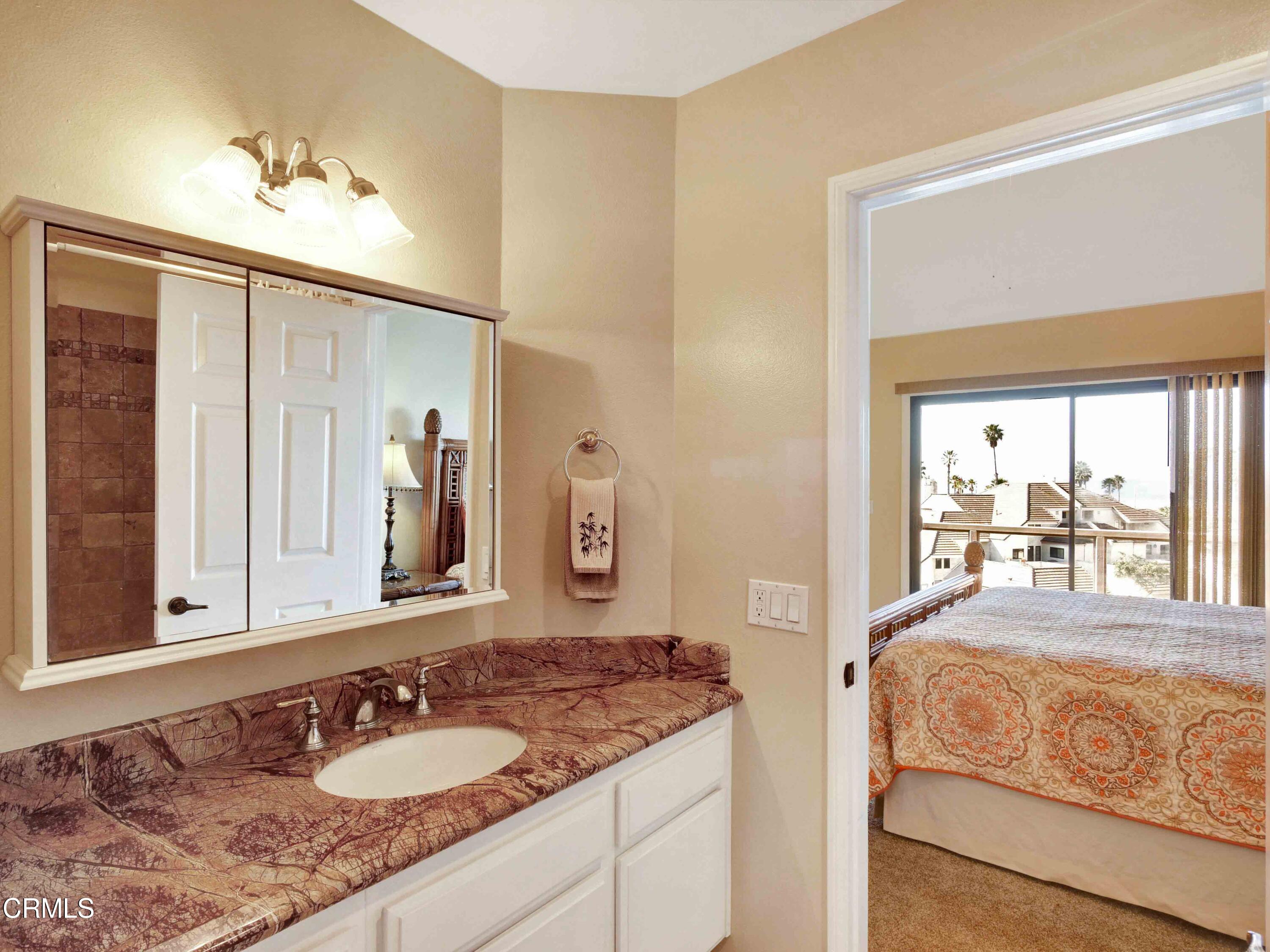 558 Terrace View Place Port Hueneme, CA 93041 - Photo 36 of 52 a en suite bathroom with a granite countertop sink and a mirror