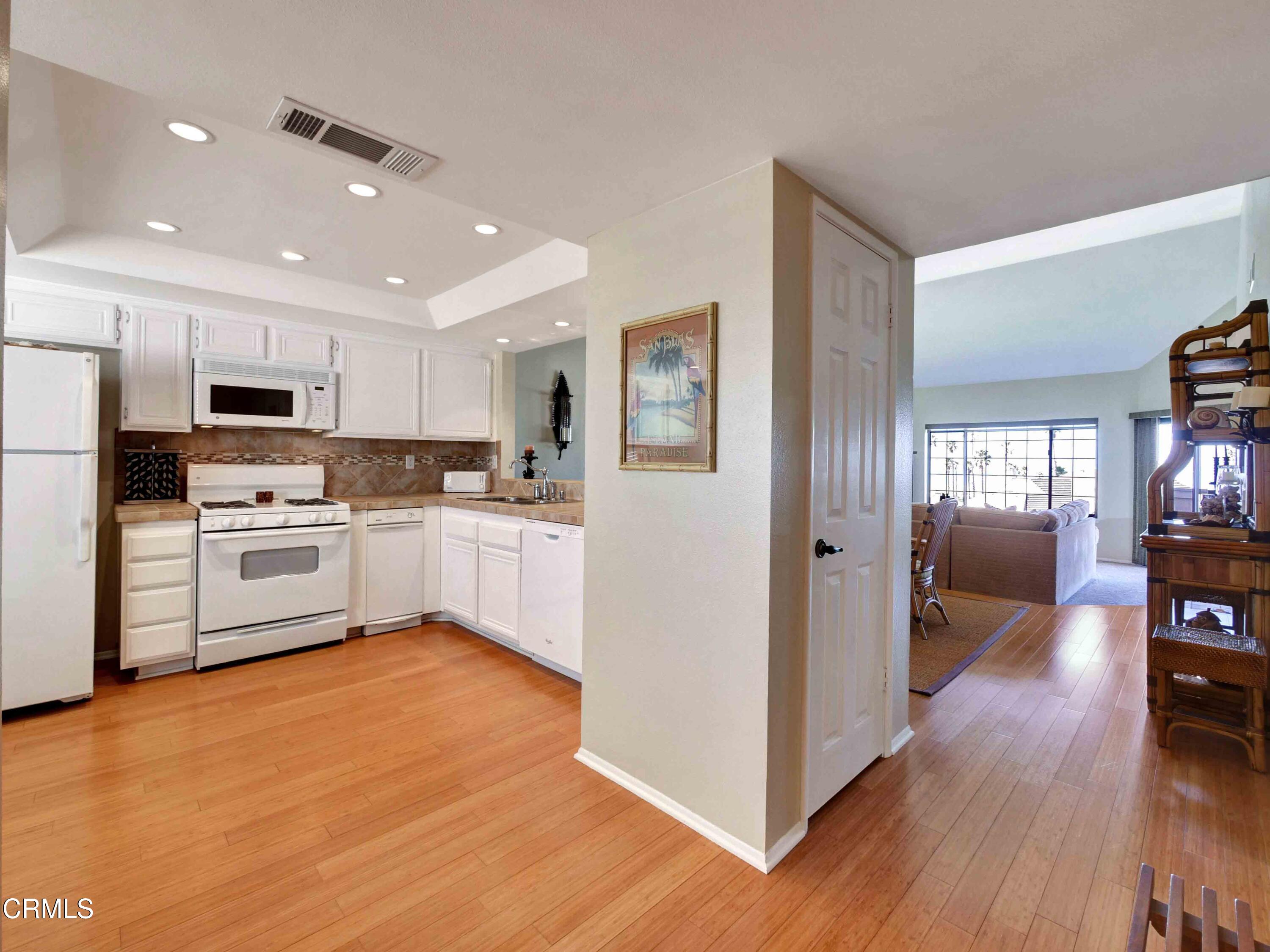 558 Terrace View Place Port Hueneme, CA 93041 - Photo 5 of 52 a kitchen with white cabinets and stainless steel appliances