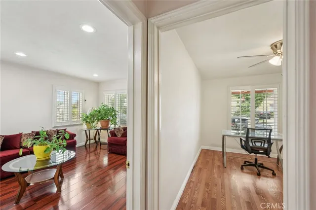a view of a work space with furniture and wooden floor