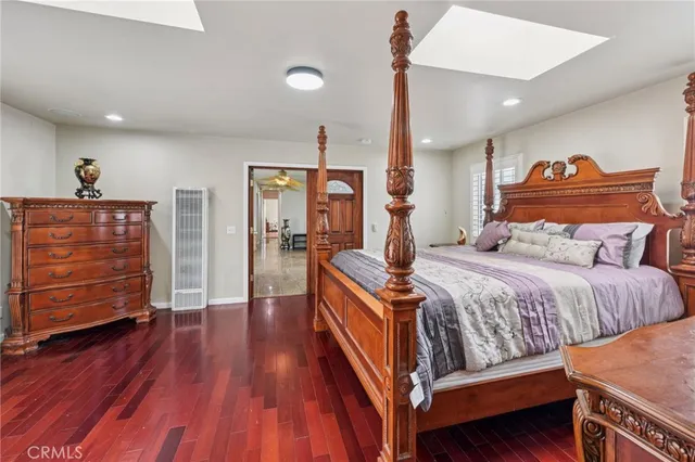 a bedroom with bed and wooden floor
