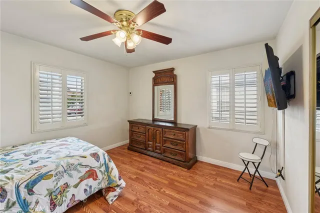a bedroom with a bed dresser and a window