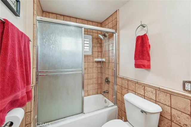 a bathroom with a toilet and a shower curtain