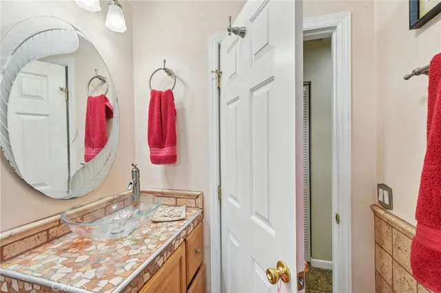 a bathroom with a sink mirror and vanity