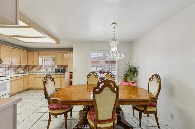 a view of a dining room with furniture and chandelier