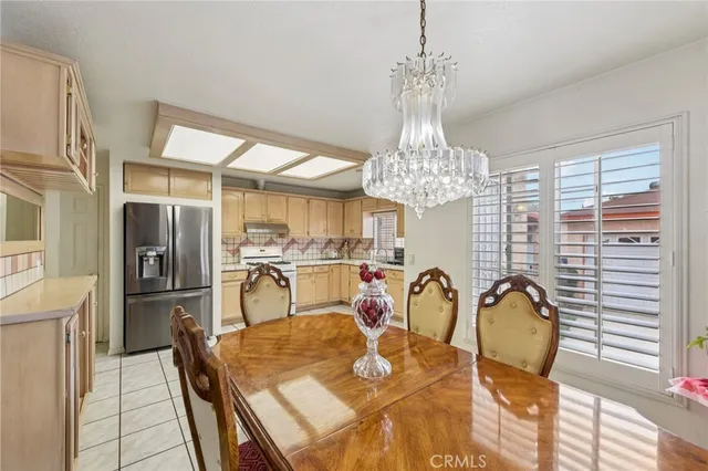 a view of a dining room with furniture and chandelier
