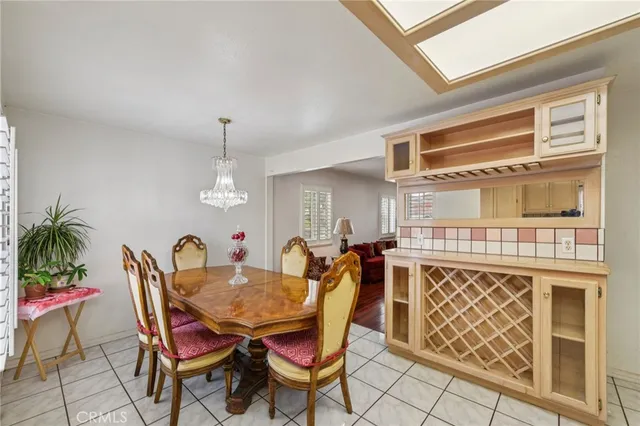 a dining room with furniture a chandelier and window
