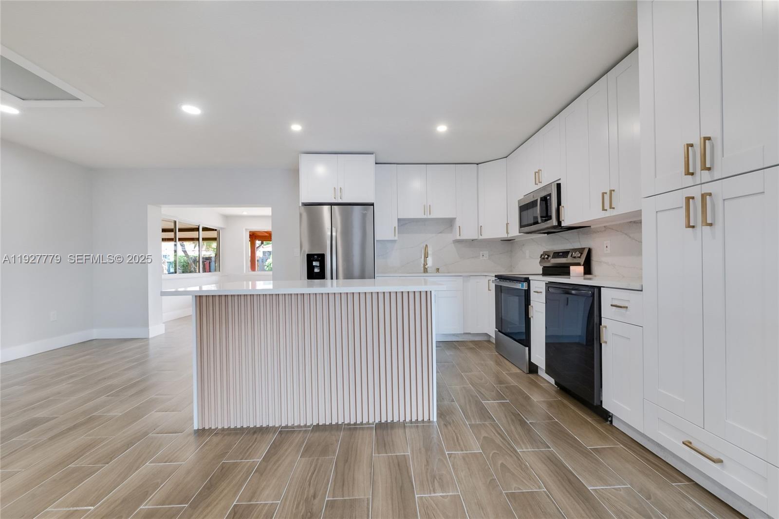 a kitchen with stainless steel appliances a refrigerator sink and microwave