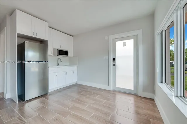 a view of a kitchen with refrigerator and microwave