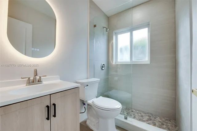 a bathroom with a sink toilet and vanity