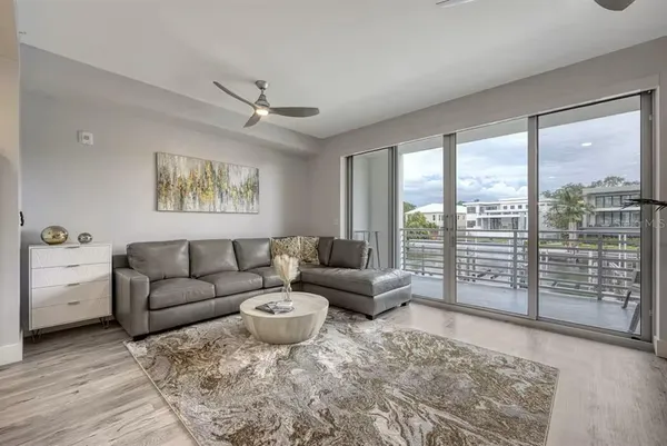 a living room with furniture and a floor to ceiling window