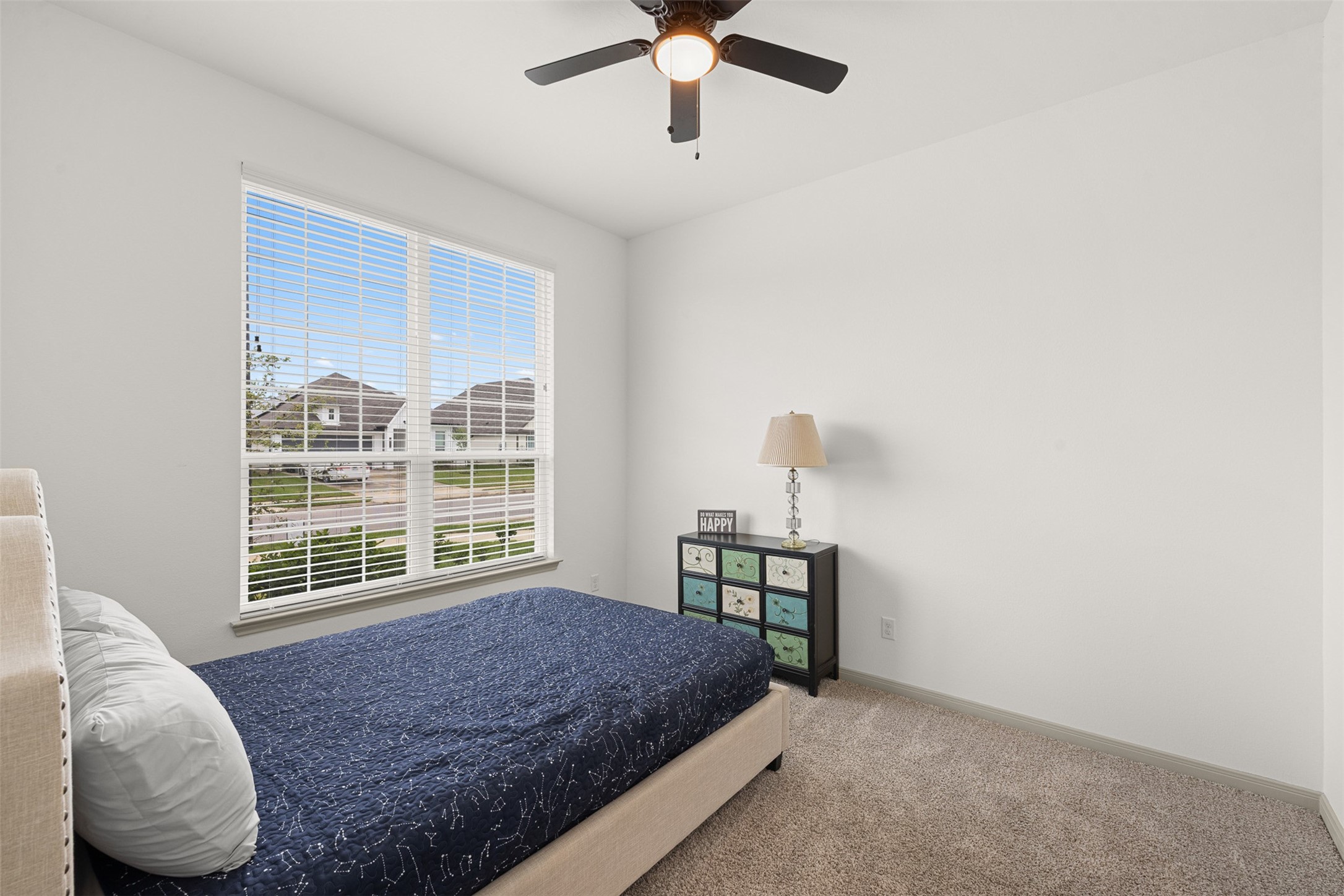 1968 Chief Street Bryan, TX 77807 - Photo 15 of 27 This bedroom features a large window with blinds, allowing plenty of natural light. The ceiling fan adds comfort and circulation.