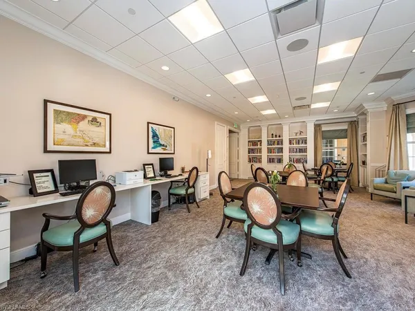 a living room with furniture a flat screen tv and a table