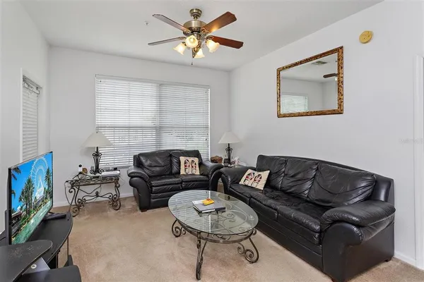 a living room with furniture a rug and a window