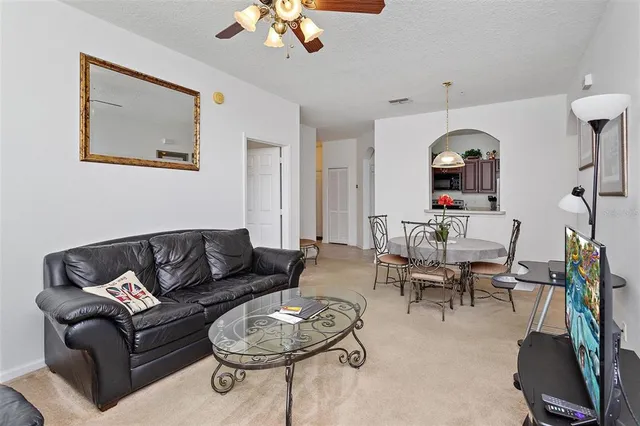 a living room with furniture and a mirror