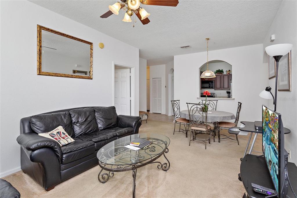 2307 Silver Palm Drive, Unit 202 Kissimmee, FL 34747 - Photo 13 of 34 a living room with furniture and a mirror