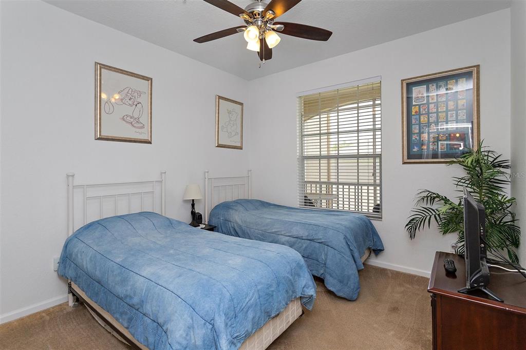 2307 Silver Palm Drive, Unit 202 Kissimmee, FL 34747 - Photo 16 of 34 a bedroom with two beds and a potted plant