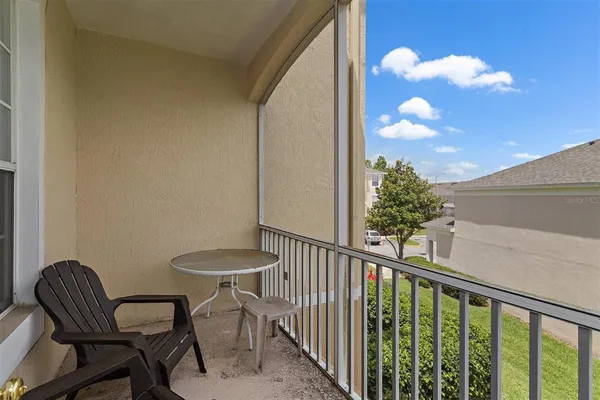 a view of a porch with furniture and a floor to ceiling window