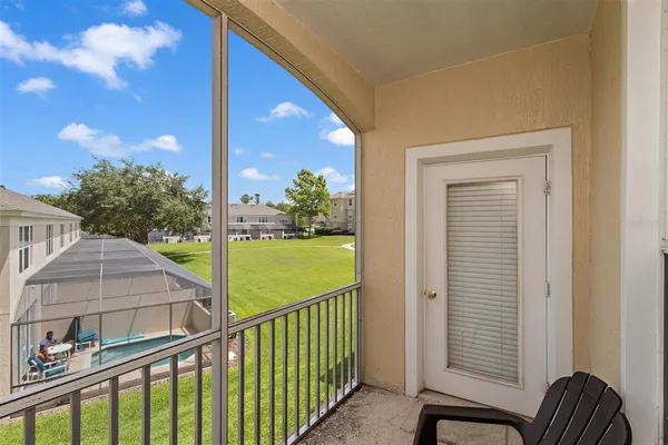 a view of balcony with floor to ceiling window and wooden fence